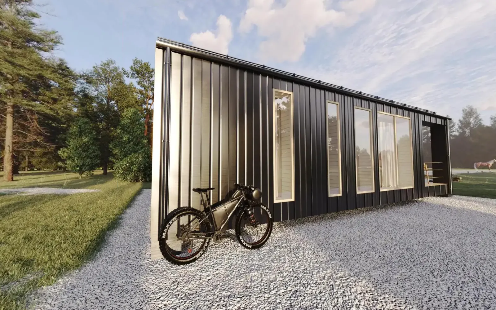360° view from a Lesmee virtual tour: a black metal-clad cabin on a gravel yard beside a pine forest